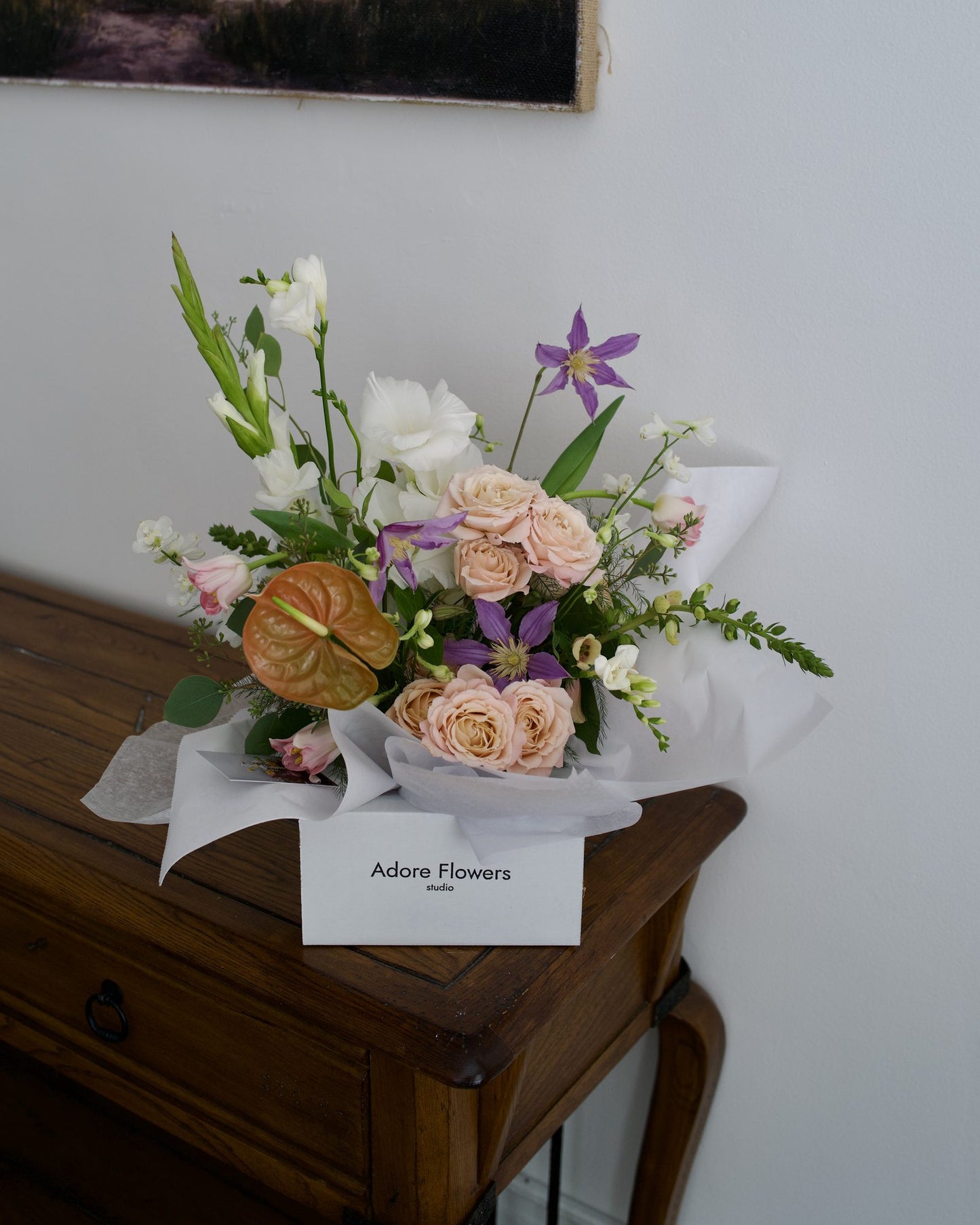 Delicate Blushes arrangement in an Adore Flowers gift box, blush roses and purple clematis, same-day delivery Los Angeles