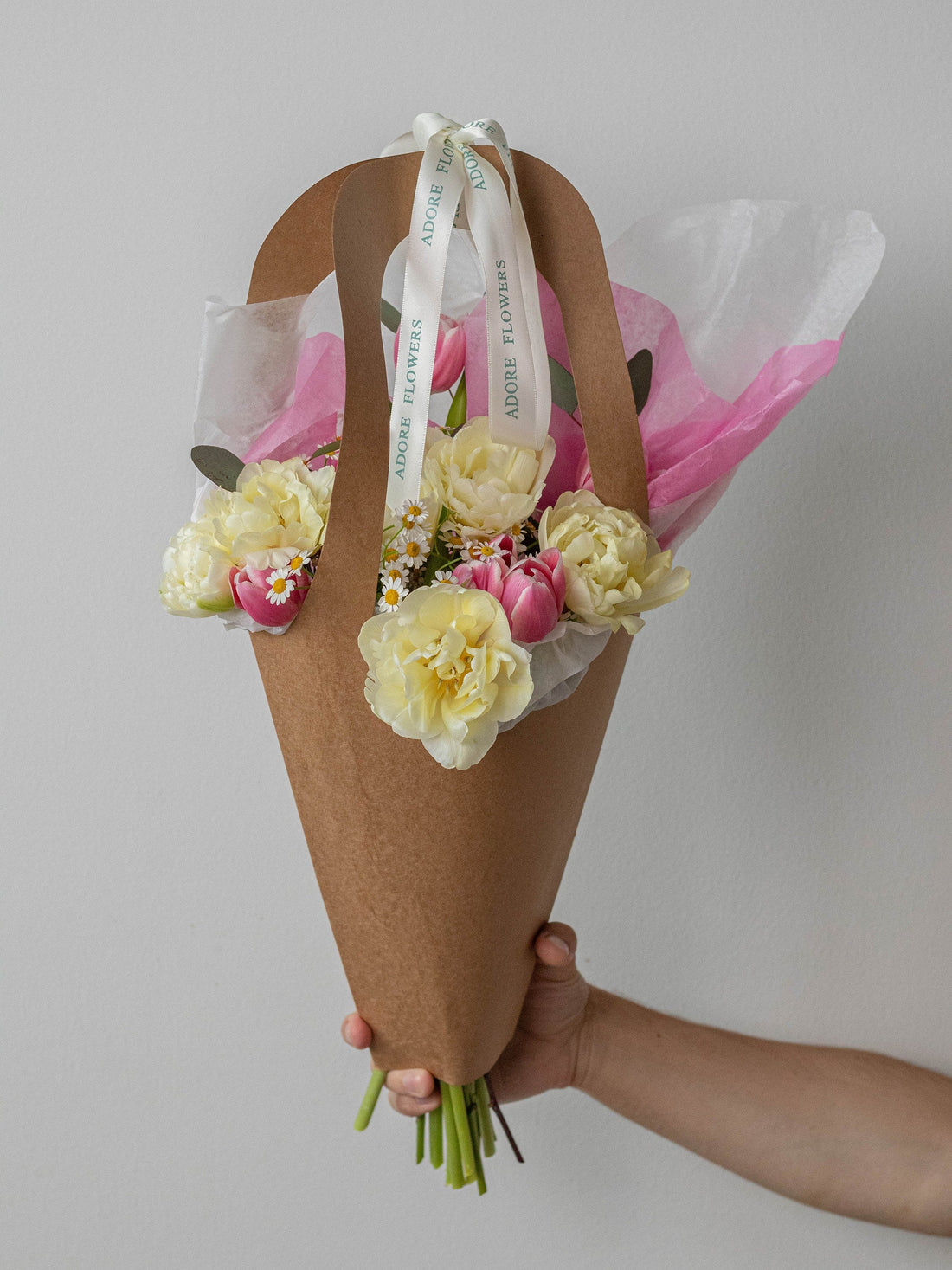 A dozen tulips wrapped in paper from Adore Flowers
