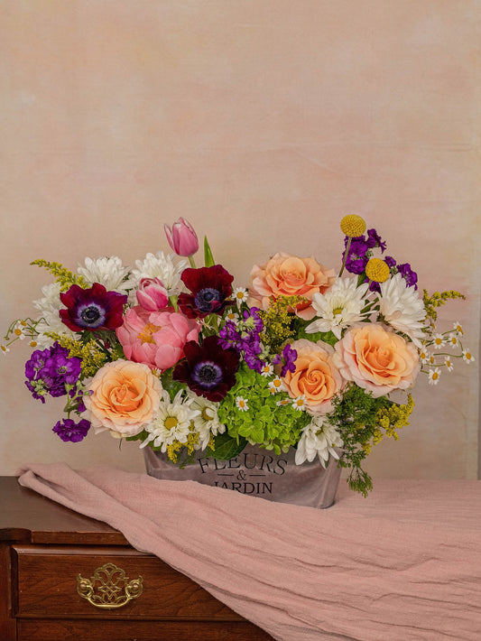 The Jardin arrangement: luxurious roses, peonies, and anemones in peach, coral, and deep purple