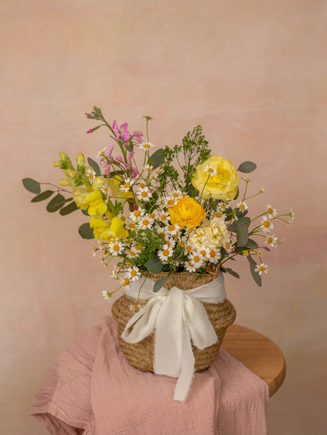 Summer seasonal basket of yellow ranunculus, snapdragons, daisies and eucalyptus, Adore Flowers, Los Angeles