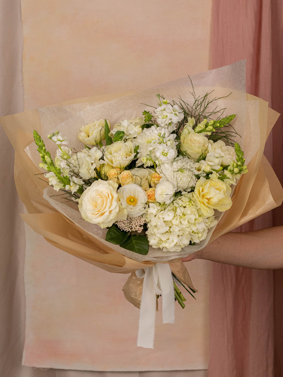 White Elegance, an Adore Flowers arrangement of white roses, ranunculus, and hydrangea in a permanent vessel