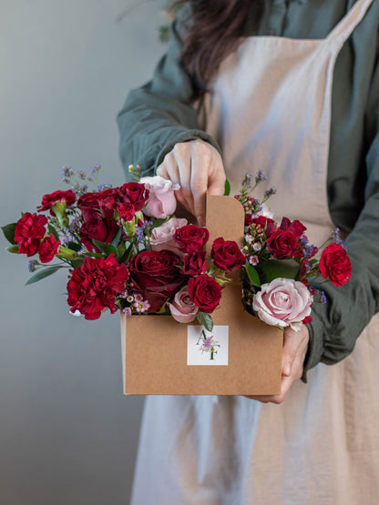 Love Garden Floral Bag - Red and Pink Roses, Mini Roses, Carnations with Lush Greenery