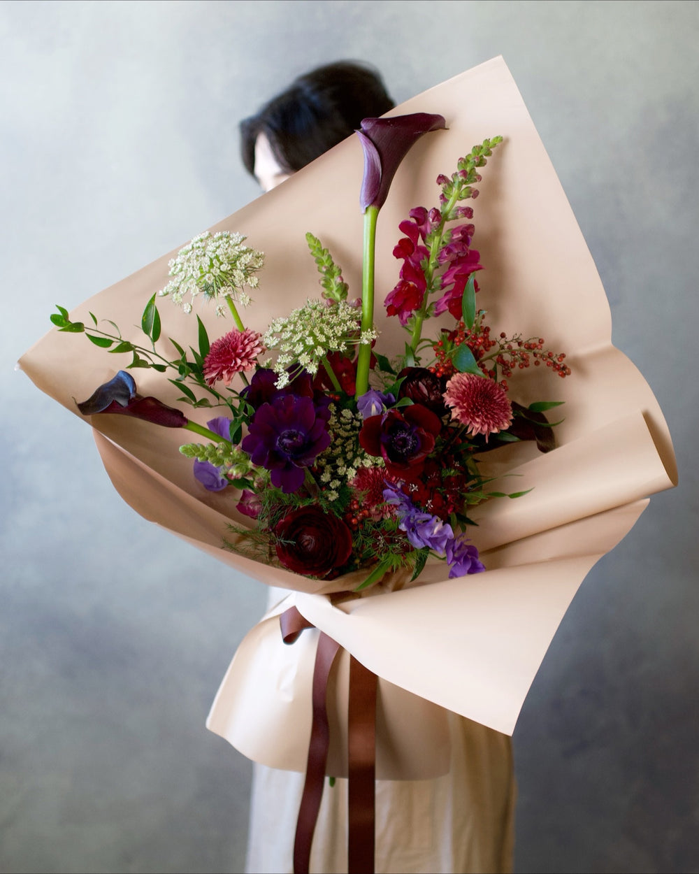 Bold & Moody bouquet, burgundy, plum and crimson blooms with dark calla lilies hand-tied in wrap, Adore Flowers Los Angeles