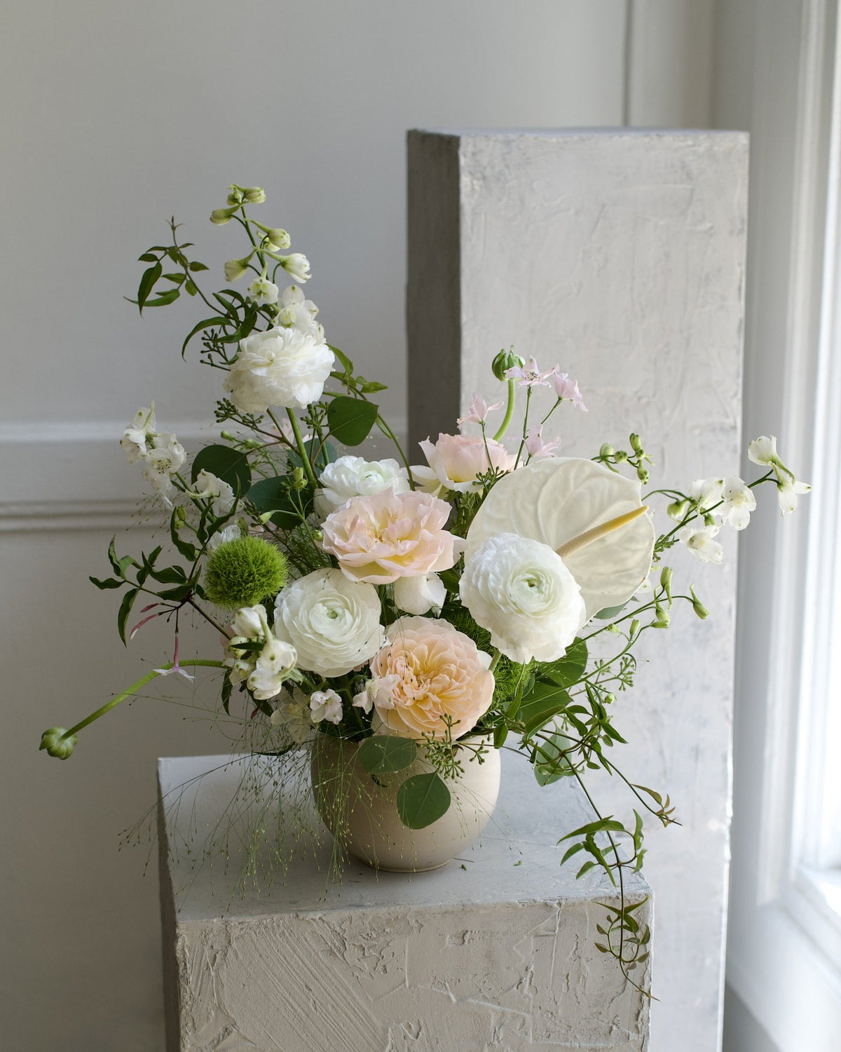 Earthy Neutrals vase arrangement variation, white ranunculus, ivory garden roses, anthurium and trailing jasmine in a ceramic vase, Adore Flowers Los Angeles
