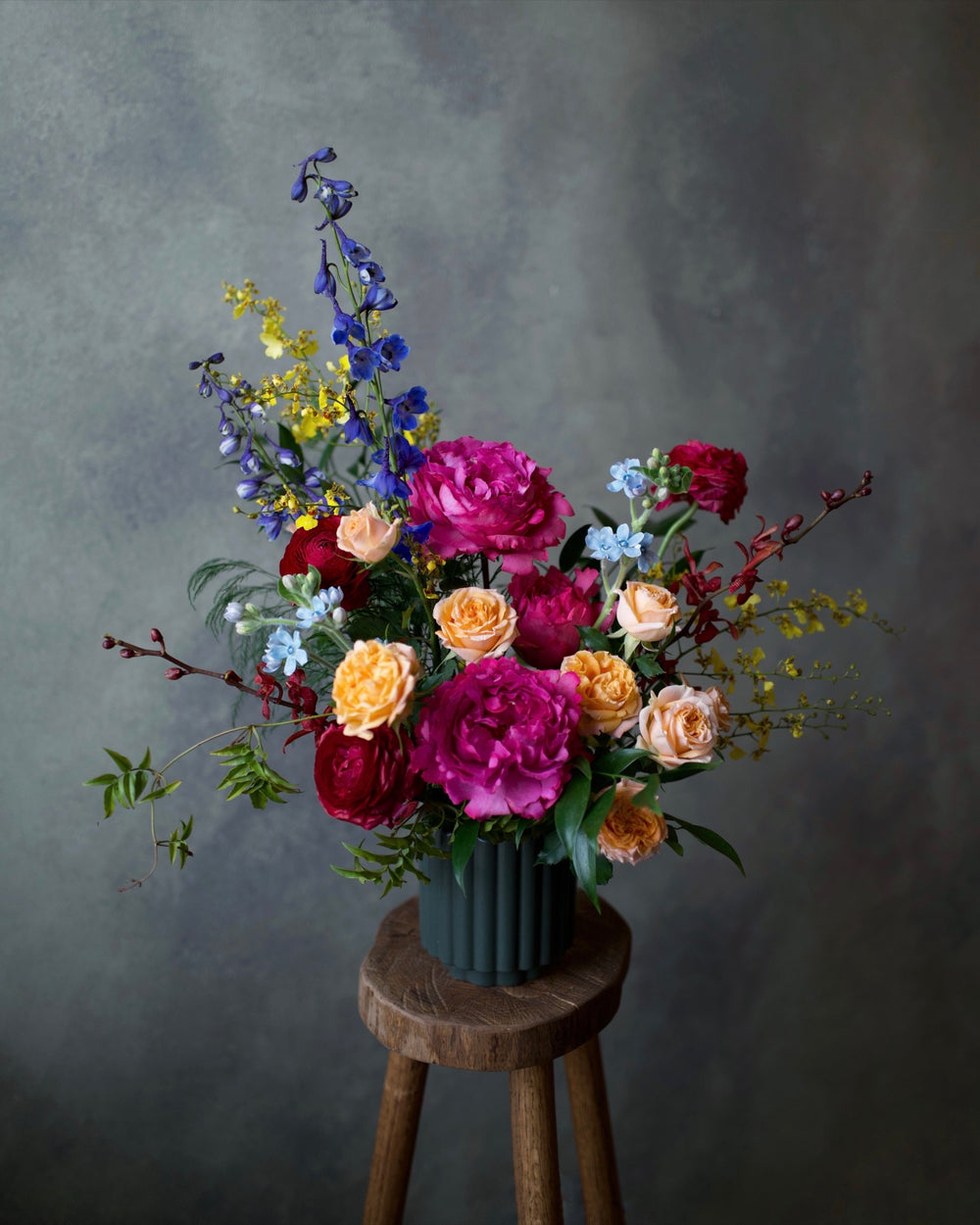Vibrant Tones arrangement in a stone vase, bright pink, coral and orange garden flowers, same-day delivery Los Angeles