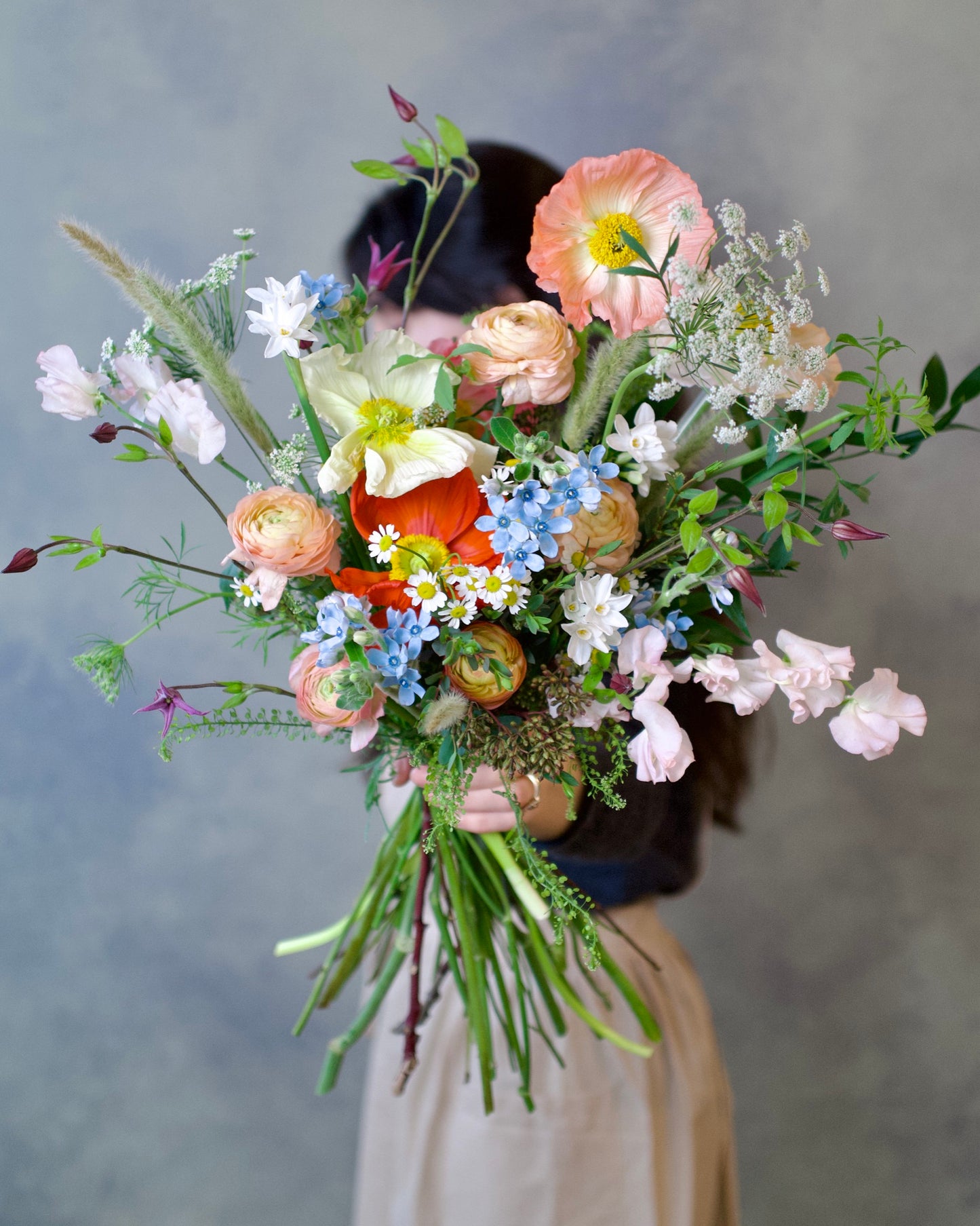 Wildflower bouquet variation with peach poppies, ranunculus, blue tweedia and sweet peas, The Wild Bunch by Adore Flowers Los Angeles
