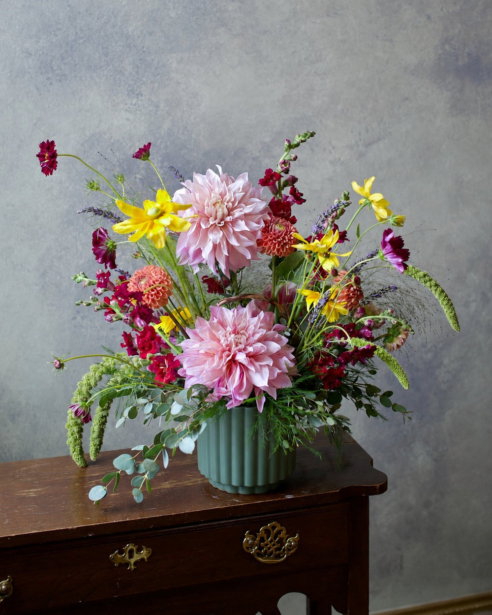 Wildflower vase arrangement with pink dahlias, burgundy cosmos and yellow blooms in a green ceramic vase, The Wild Bunch by Adore Flowers Los Angeles