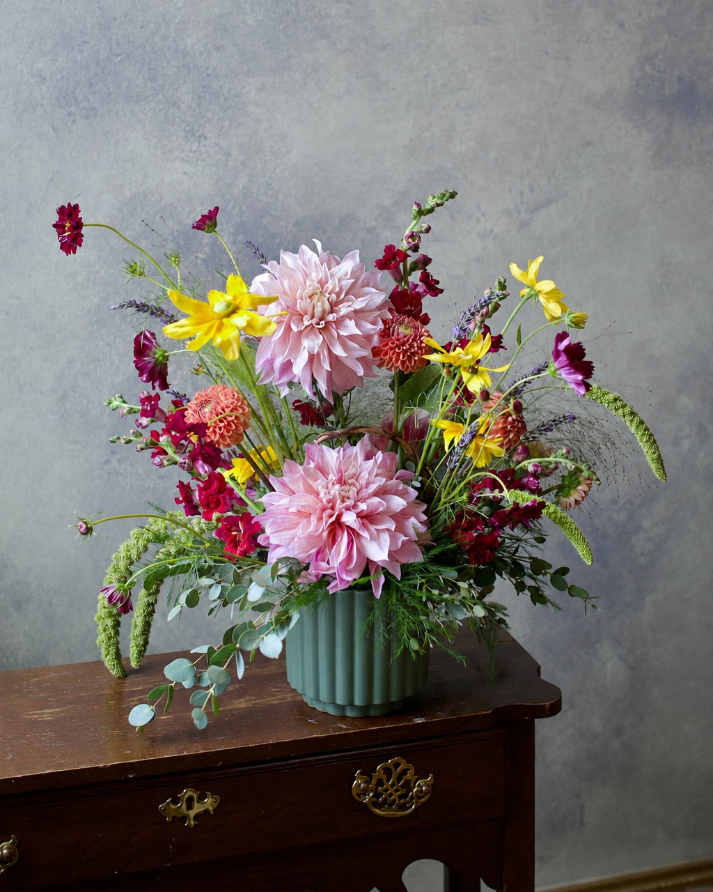 Wildflower vase arrangement with pink dahlias, burgundy cosmos and yellow blooms in a green ceramic vase, The Wild Bunch by Adore Flowers Los Angeles